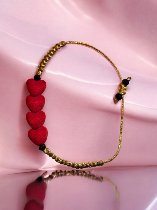 Gold Macrame bracelet adorned with four soft red velvet heart charms